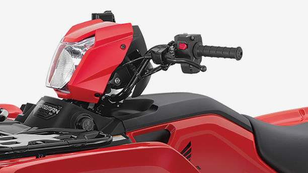 An up close view of the handlebars of a Honda Foreman
