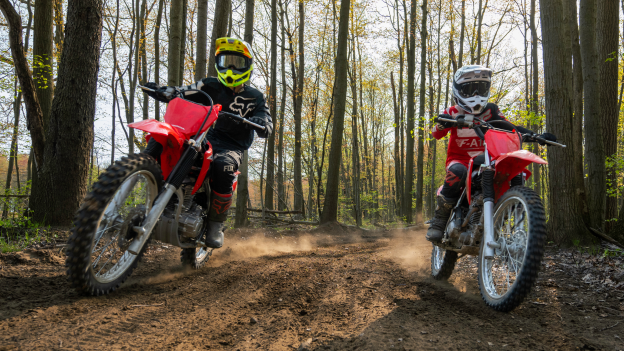 Two riders on Honda CRF Trail dirt bikes