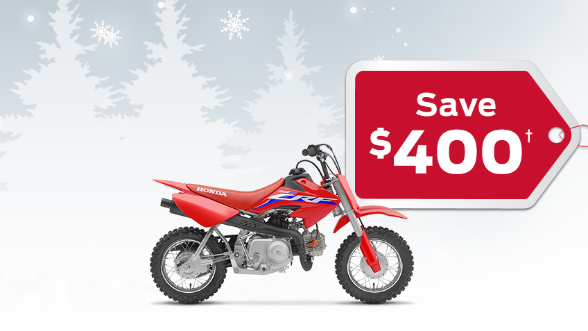 A CRF50F on a winter background with snowflakes with a save $400 gift tag advertising a $400 discount