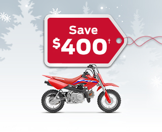 A CRF50F on a winter background with snowflakes with a save $400 gift tag advertising a $400 discount